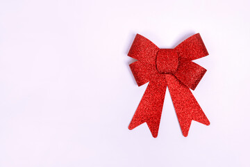 Red gift bow with sequins. Ribbon. Isolated on white background with copy space