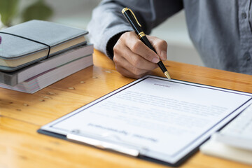 Businessman signing a legal real estate contract agreement, home Insurance.