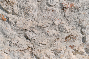 Background of stone white wall covered with plaster. Vintage style, idea for background or wallpaper with copy space