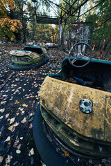 Abandoned Amusement Car Ride in Ghost City of Pripyat in Chernobyl Exclusion Zone, Scooter in Autumn Colors