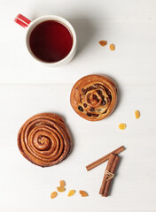 Layout for the cover, screensaver, poster . Autumn content with a cup of tea, homemade buns and dry bright autumn leaves