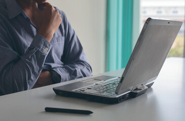 Business men are thinking hard about job on laptop