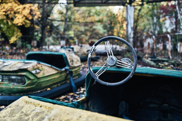 Abandoned Amusement Car Ride in Ghost City of Pripyat in Chernobyl Exclusion Zone, Scooter in Autumn Colors