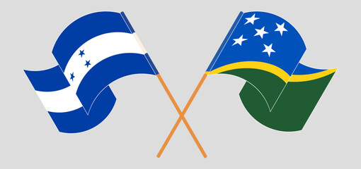 Crossed and waving flags of Honduras and Solomon Islands