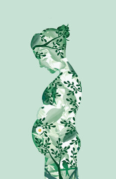 Happy mother in a green dress laying her hand on her tummy 