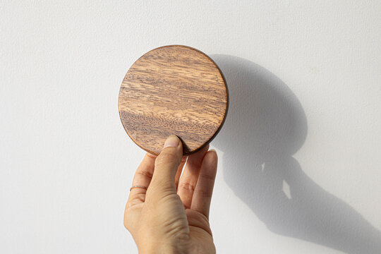 Wood Circle Coaster Holding With Left Hand