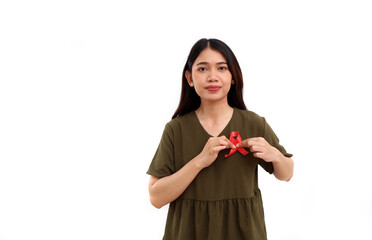Young asian woman standing while holding red ribbon on her chest. Aids campaign concept. Isolated with copyspace