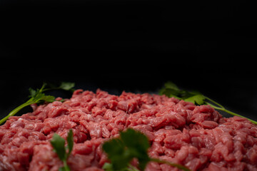 Chopped raw meat. Cut beef into small pieces on blake plate