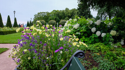 A park with trees and flowers in a city