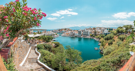 Agios Nikolaos, crete island, greece: view over lake Voulismeni (Vouliagmeni) and the pittoresk harbour city - obrazy, fototapety, plakaty