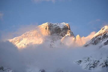 Garhwal Himalayas snow peaks in the blue sky covered by the floating clouds in India