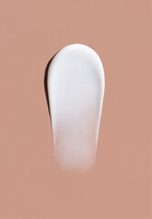 cosmetic smears cream texture on pastel brown background