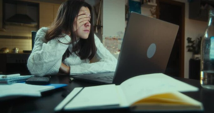 Tired worker sleeping on the desk in front of computer working at home on night