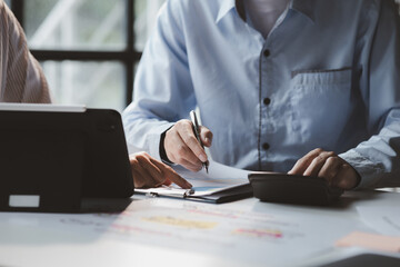 The sales department is having a monthly summary meeting to bring it to the department manager, they are verifying the correctness of the documents that are prepared before bringing in to the manager