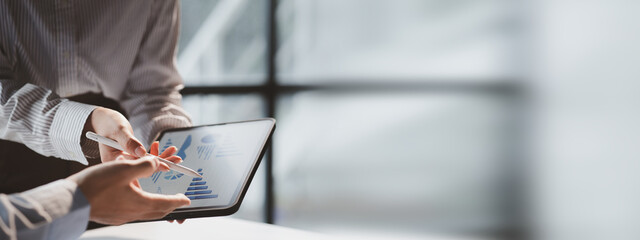 A meeting of two businessmen brainstorming a marketing plan and analyzing sales to come up with strategies for marketing to increase the company's sales. Business administration concept.