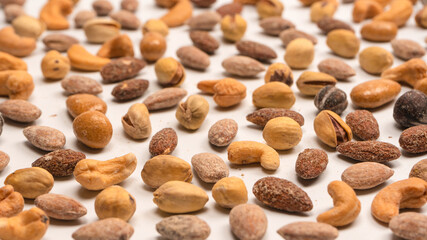  A group of almonds, pistachios, walnuts, macadamia, cashews.