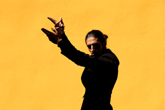 Hispanic flamenco dancer in black suit