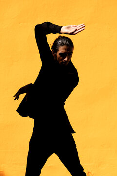 Graceful man in suit dancing flamenco