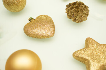 various golden christmas ornaments on white background