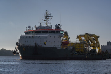 MARITIME ENGINEERING - Cable laying vessel is sailing along the port channel to the sea