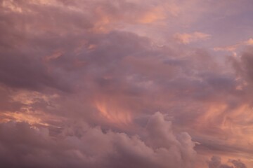 Golden purple sunset behind the thick clouds