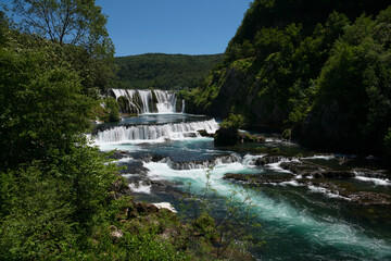 Fototapeta na wymiar Beautiful river waterfall landscape nature in summer clear water and forest. 