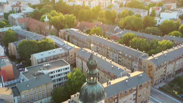 High-angle video panning over Cottbus city with the golden evening sun setting on the horizon
