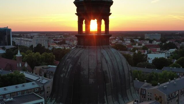 High-angle video panning over Cottbus city with the golden evening sun setting on the horizon