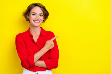 Photo of adorable cute nice pretty woman with bob hairstyle wear red shirt indicating empty space isolated on yellow color background