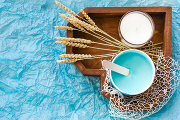 Sugaring blue mint paste in heart shaped wooden box in beauty salon. View from above