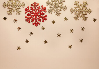 Christmas gold and red flakes on pastel background, horizontal, flat lay