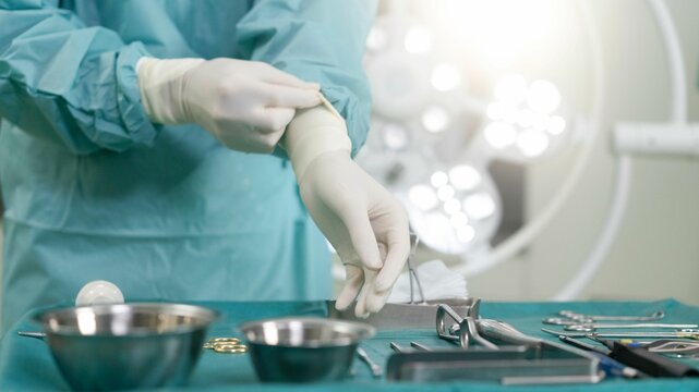 Closeup shot of a doctor with gloves using surgical instruments before the surgery starts