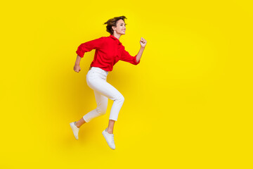 Fototapeta na wymiar Full length profile portrait of active sportive person running jump isolated on yellow color background