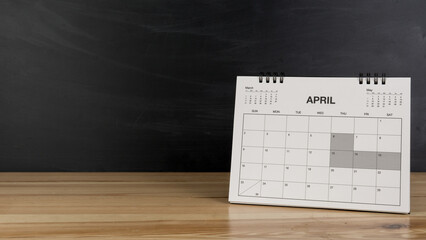 April calendar on wood desk blackboard background.
Apr 2023 agenda.