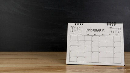 February calendar on wood desk white background.
 Feb 2023 agenda concept.