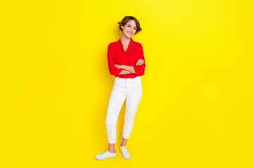 Fototapeta na wymiar Full size photo of pretty positive girl crossed arms toothy smile isolated on yellow color background