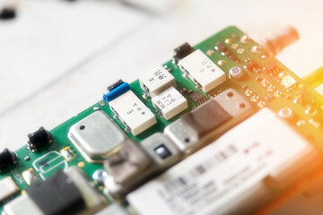 Board with chips, electronic chips, transistors and capacitors close-up. Electronic device detail with selective focus. Background. Import and replacement of electronic processors from China.