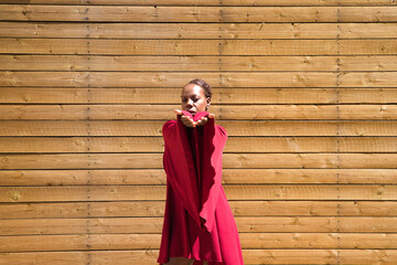 Young beautiful Afro-American woman doing different body postures and expressions on a wooden background. happy, sad, fun, thinking. Concept expressions.