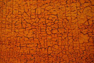 Abstract orange background with cracked texture. Empty back.