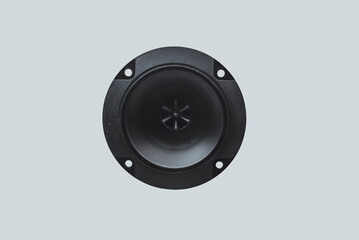 A typical black piezoelectric tweeter. Isolated on a light gray background.