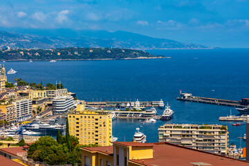 Panoramic view of Monaco metropolitan area with Monte Carlo, Carrieres Malbousquet and Les Revoires quarters over Hercules Port at French Riviera coast