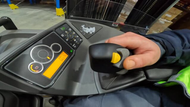 Operating a modern forklift close-up. Forklift control joystick