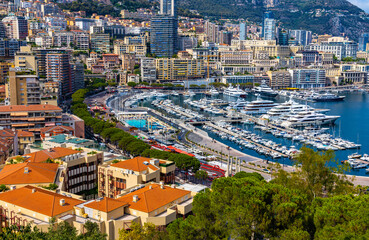 Fototapeta premium Panoramic view of Monaco metropolitan area with Hercules Port, La Condamine, Monte Carlo and Fontvieille quarters at Mediterranean Sea coast