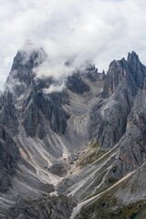 Vertical shot of rocky mountains under cloudy sky © Roberto Orlandi/Wirestock Creators