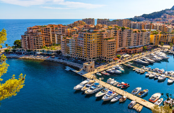 Panoramic view of Monaco metropolitan area with Port Fontvielle yacht marina with surrounding residences at Mediterranean Sea coast
