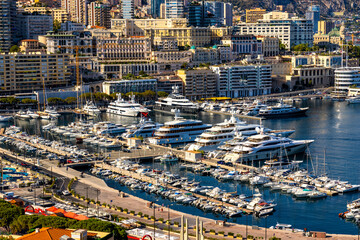 Fototapeta na wymiar Panoramic view of Monaco metropolitan area with Hercules Port, Monte Carlo and Fontvieille quarters at Mediterranean Sea coast