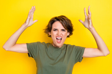Portrait of furious angry unhappy woman with bob hairdo dressed khaki t-shirt loud shout palms up...
