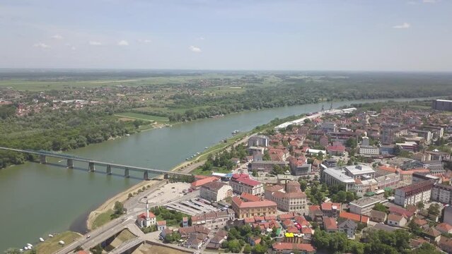Aerial of a river in the Brcko district with a bridge connecting the lands, Bosnia and Herzegovina
