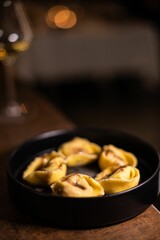 Closeup shot of spiced dumplings in a small black pan