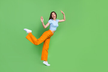 Full length profile photo of satisfied overjoyed person standing one leg raise hands isolated on...